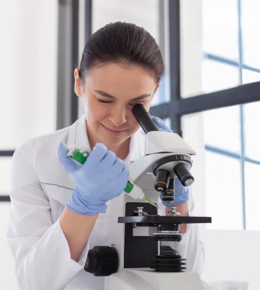 Laboratory technician working with a microscope