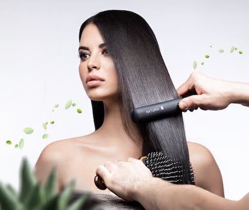 A woman getting her Hair straightened